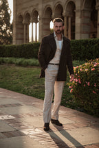 Man standing on a stone path with classical architecture in the background