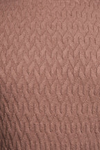 Close-up of a textured brown fabric surface
