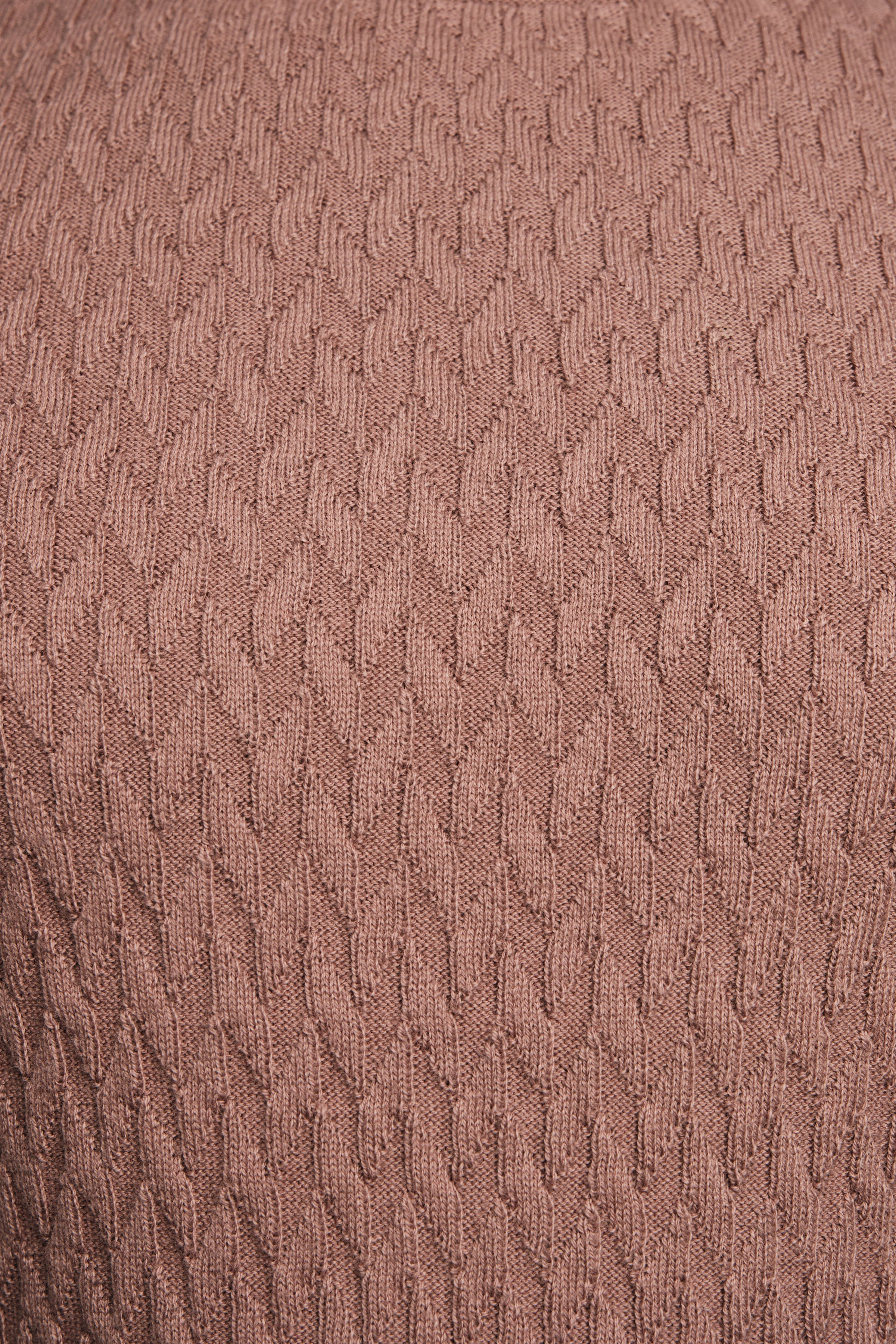Close-up of a textured brown fabric surface