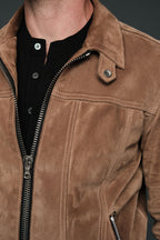 Close-up of a brown suede jacket with a zipper
