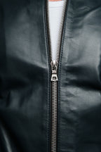Close-up of a navy leather jacket with a silver zipper